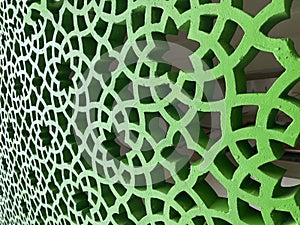 The shape of the stacked flower pattern on the green wall