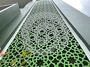 The shape of the stacked flower pattern on the green wall