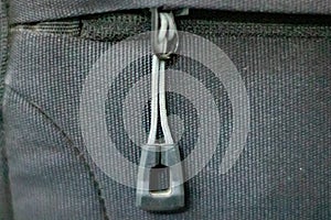 The shape of the zipper on a black bag