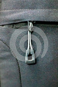 The shape of the zipper on a black bag