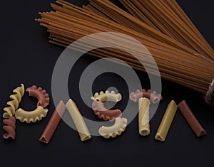 Shaped and colorful pasta in different  sizes and colors together from close range.