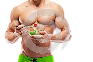 Shaped and healthy body man holding a fresh salad bowl,shaped ab