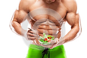 Shaped and healthy body man holding a fresh salad bowl,shaped ab