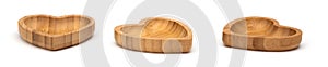Shaped heart wooden bowls isolated on white. Set of empty wood bowls for dry fruits and nuts in collage for your design.