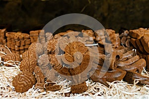 Shaped souvenir chocolate in the form of lions and women`s shoes in the shop window. Selective focus