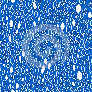 Shapeless modern white drops on a blue background are hand-drawn in the form of spots. Seamless trendy pattern for fabrics.