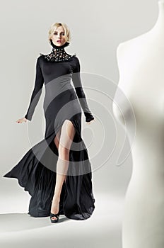 Shapely, alluring blond lady in black gown