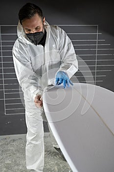 Shaper working on surf board