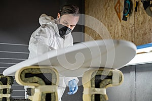 Shaper working on surf board