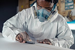 Shaper working on surf board