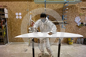 Shaper working on surf board