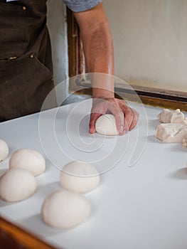 Shaping bun dough by hand