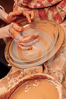 Shaping cay on pottery wheel