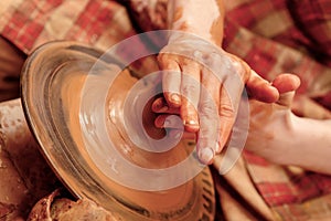 Shaping cay on pottery wheel