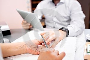 Shaping the nail to a perfect form during a manicure treatment