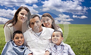 Shappy Hispanic Family Portrait Sitting in Grass Field