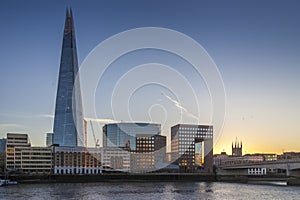 The Shard and London Bridge by river Thames during sunset photo