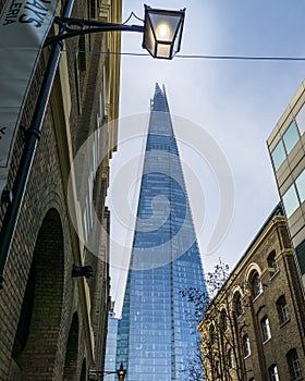 The Shard skyscraper with grey clouds in the sky.
