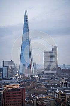 The Shard skyscraper with grey clouds in the sky.