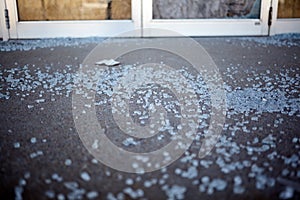 Shards of shattered glass on a sidewalk