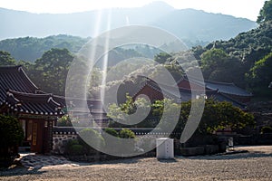 Shards of sunlight bless korean temple building daylight colour in mountains