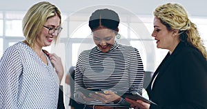 Share, inform, connect. 4k video footage of a group of women using a digital tablet together at a convention center.