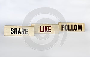 Share, like and follow wooden blocks and white background