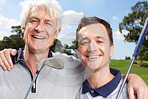 We share a love of golf. Happy father and son golfing team together on the course.