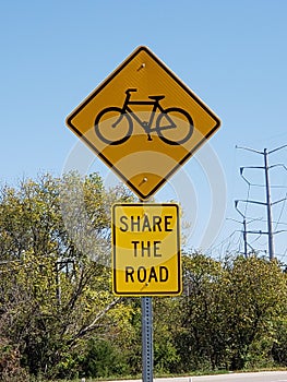 Share the road with bicycles sign natural setting