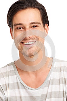 Share the secret of youthful exuberance. Closeup of a laughing young man in a striped t-shirt, isolated on white -