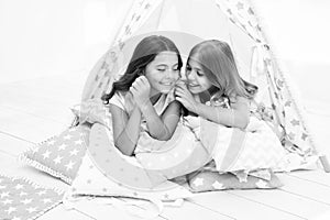 Share secrets concept. Girls cute children lay relaxing in teepee bedroom. Cute space for leisure. Modern interior