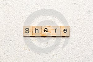 share word written on wood block. share text on table, concept