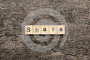 share word written on wood block. share text on table, concept