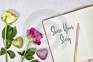 share your story concept om notebook with roses flowers and hearts glitters