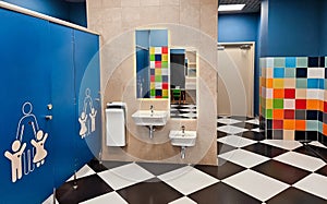 Shared family bright restroom in airport, mall. Unisex WC for mom, dad,little girl boy,child kid. Use together