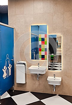 Shared family bright restroom in airport, mall. Unisex WC for mom, dad,little girl boy,child kid. Use together
