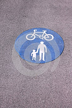 Shared foot and cycle path roundel sign painted on path
