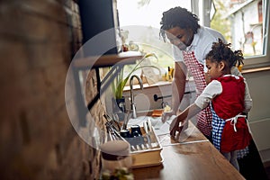 Shared Responsibilities: Afro-American Father and Daughter Tackling Dishwashing Together