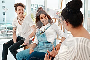 We are always sharing creative ideas. a diverse group of friends sitting together and talking during an art class in the