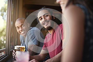 Sharing drinks and laughs. a group of friends enjoying themselves in the pub.