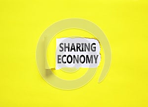 Sharing economy symbol. Concept words Sharing economy on beautiful white paper. Beautiful yellow paper background. Business