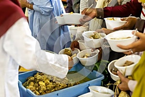 Sharing food on Kirab ketupat. Kirab ketupat is a celebration of Eid al-Fitr by distributing free food