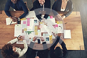 Sharing ideas will make us all successful. High angle shot of a team of businesspeople working around a table in the