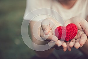 Sharing Love and Heart red color on women hand photo