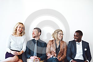 Sharing our success stories. a group of entrepreneurs sitting against a white background.