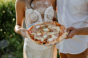 sharing a pizza, in casual prewedding clothes