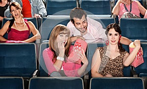 Sharing Popcorn in a Theater photo