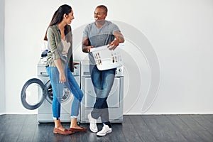 Sharing stained clothes jokes. a young woman doing laundry at home.