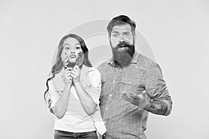 Sharing sweets with dearest people. Girl child and dad hold colorful lollipops. Sweet dessert. Bearded hipster good