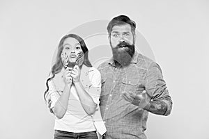 Sharing sweets with dearest people. Girl child and dad hold colorful lollipops. Sweet dessert. Bearded hipster good photo